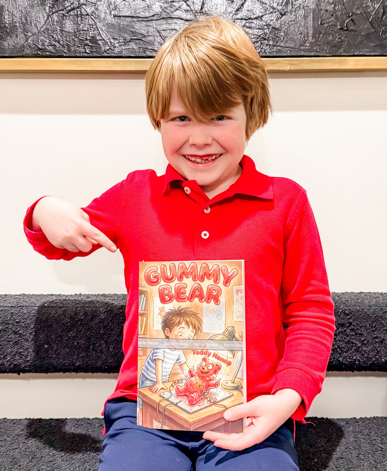 Teddy Hanna, 9-year-old author, holding his book Gummy Bear